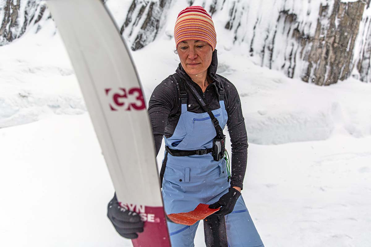 Flylow Gear Foxy women's ski bib (putting skins on skis)